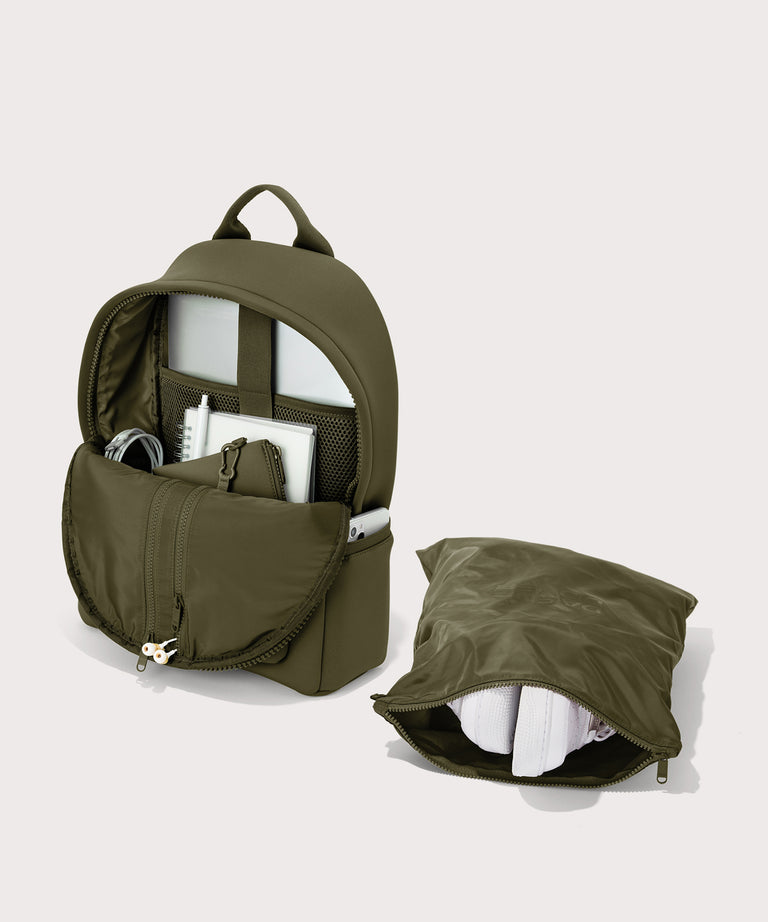 Dagne Dover medium Dakota Neoprene Backpack in dark moss unzipped, showing the interior pockets and shoe bag.