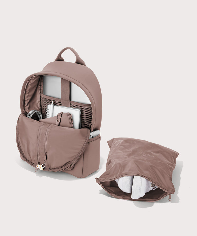 Dagne Dover medium Dakota Neoprene Backpack in pink unzipped, showing the interior pockets and shoe bag.