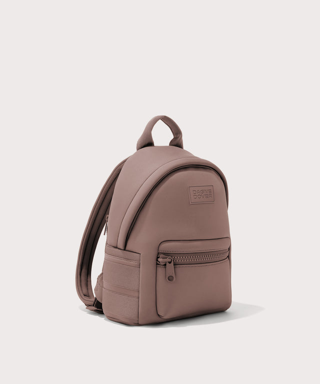 Dagne Dover small Dakota Neoprene Backpack in pink seen from an angle.
