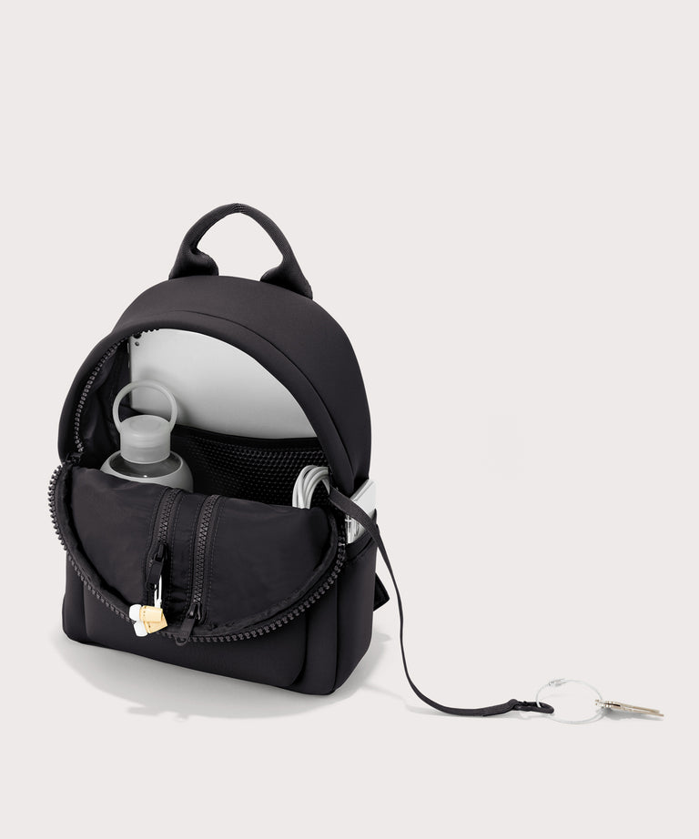Dagne Dover Dakota Small Neoprene Backpack in black unzipped, revealing the interior air mesh pockets.