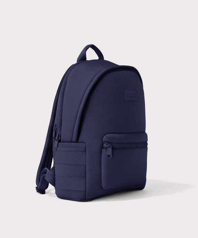 Dagne Dover large Dakota Neoprene Backpack in dark blue seen from an angle.
