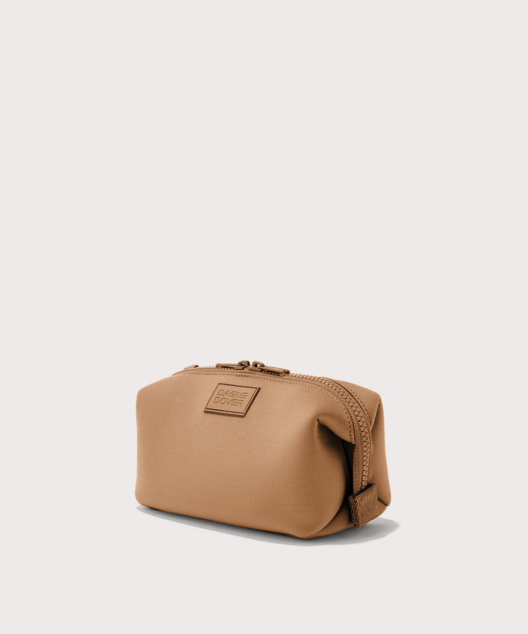 Dagne Dover Small Hunter Toiletry Bag in camel seen from an angle.
