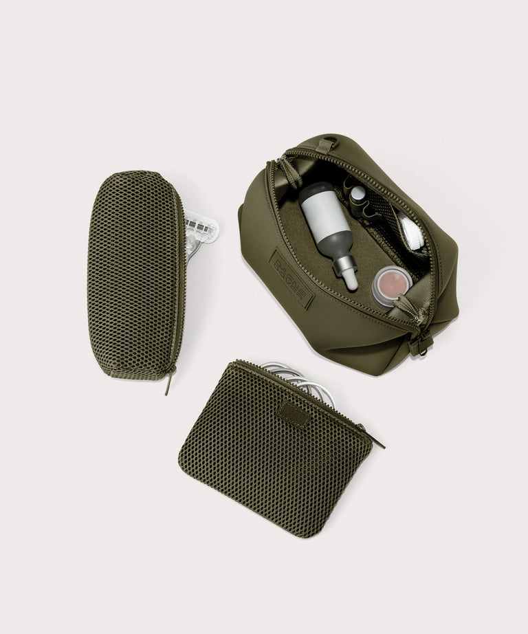 Dagne Dover Large Hunter Toiletry Bag in dark moss unzipped and seen from above with the removable air mesh pouch alongside it.