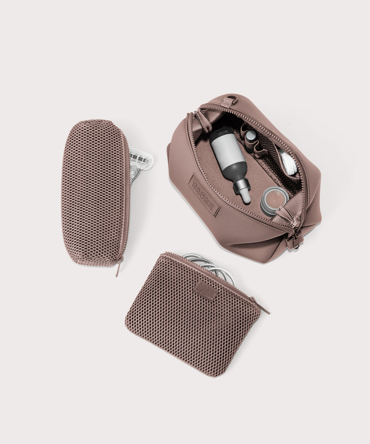 Dagne Dover Large Hunter Toiletry Bag in pink unzipped and seen from above with the removable air mesh pouch alongside it.