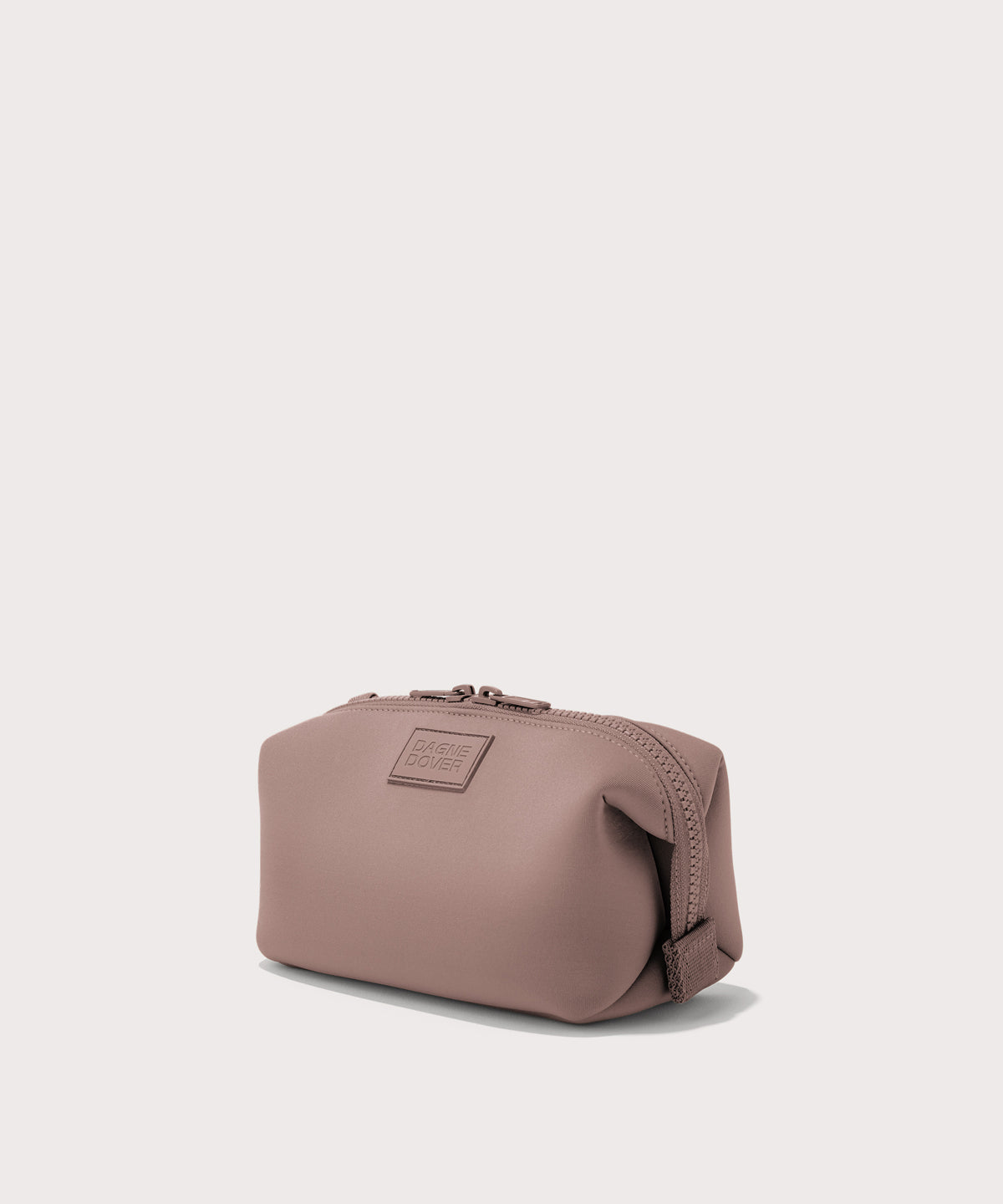 Dagne Dover Small Hunter Toiletry Bag in pink seen from an angle.
