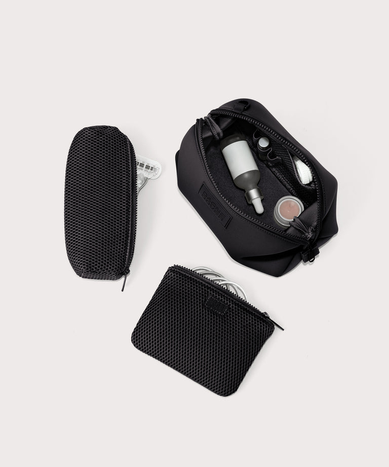 Dagne Dover Large Hunter Toiletry Bag in black unzipped and seen from above with the removable air mesh pouch alongside it.