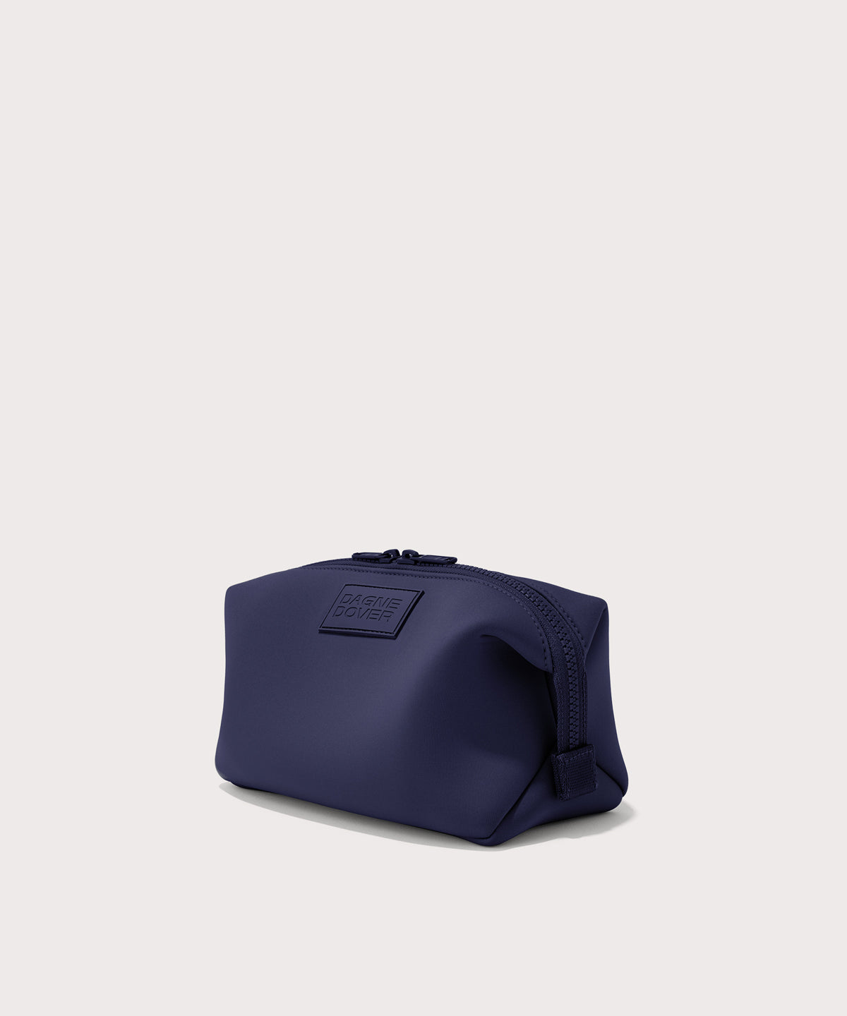 Dagne Dover Large Hunter Toiletry Bag in dark blue seen from an angle.
