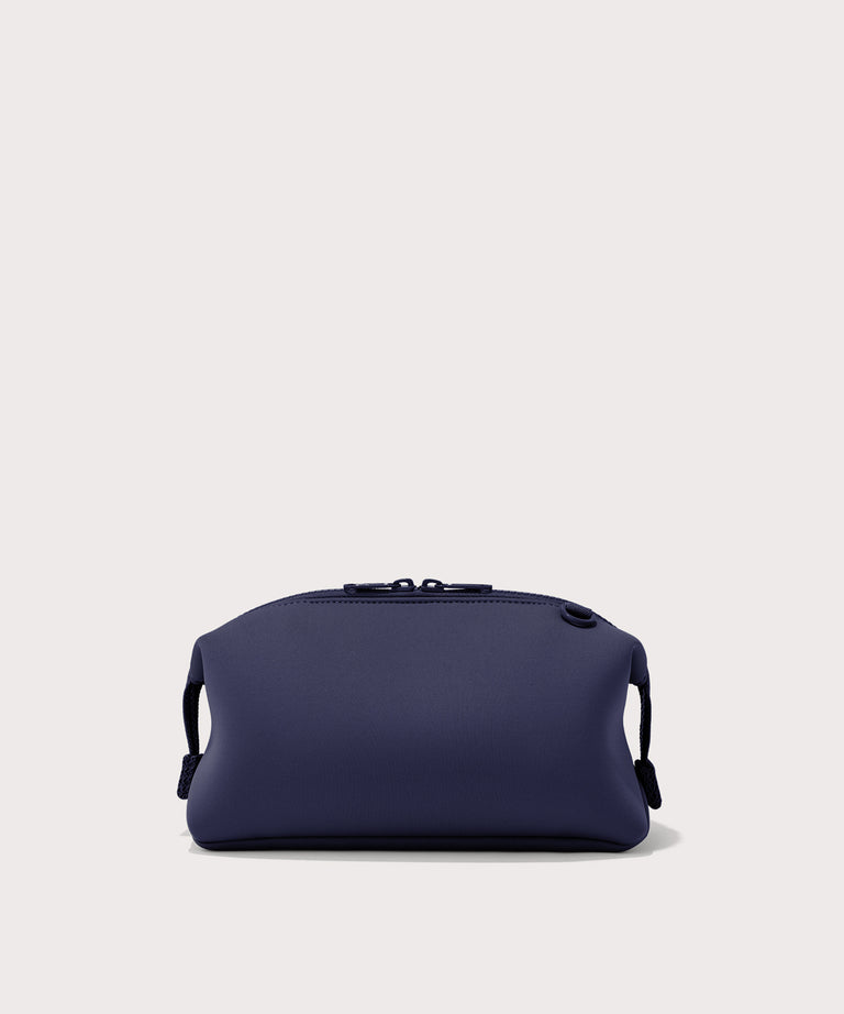 Dagne Dover Large Hunter Toiletry Bag in dark blue seen from the back.
