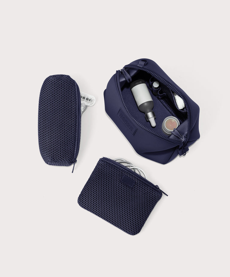 Dagne Dover Large Hunter Toiletry Bag in dark blue unzipped and seen from above with the removable air mesh pouch alongside it.