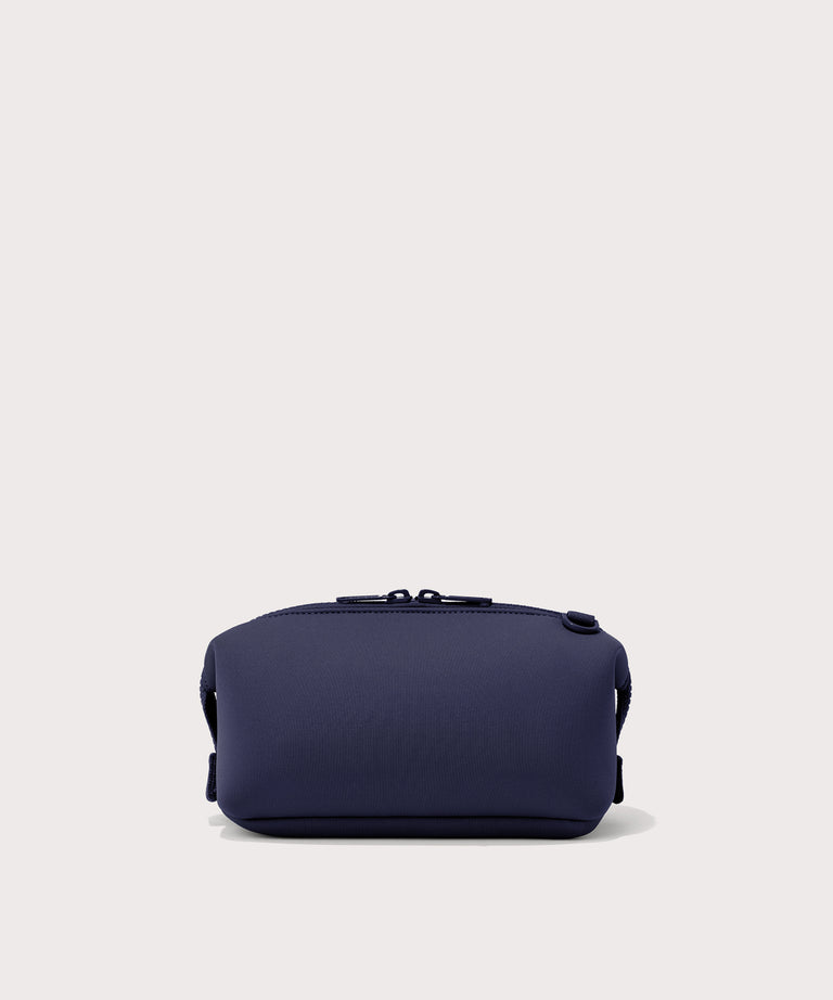 Dagne Dover Small Hunter Toiletry Bag in dark blue seen from the back.
