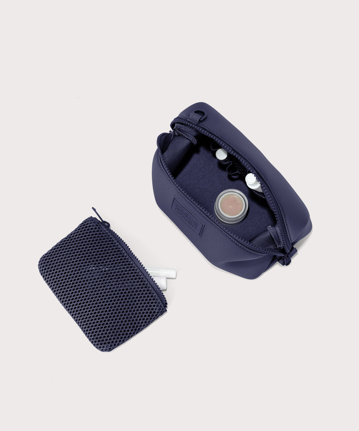 Dagne Dover Small Hunter Toiletry Bag in dark blue unzipped and seen from above with the removable air mesh pouch alongside it.