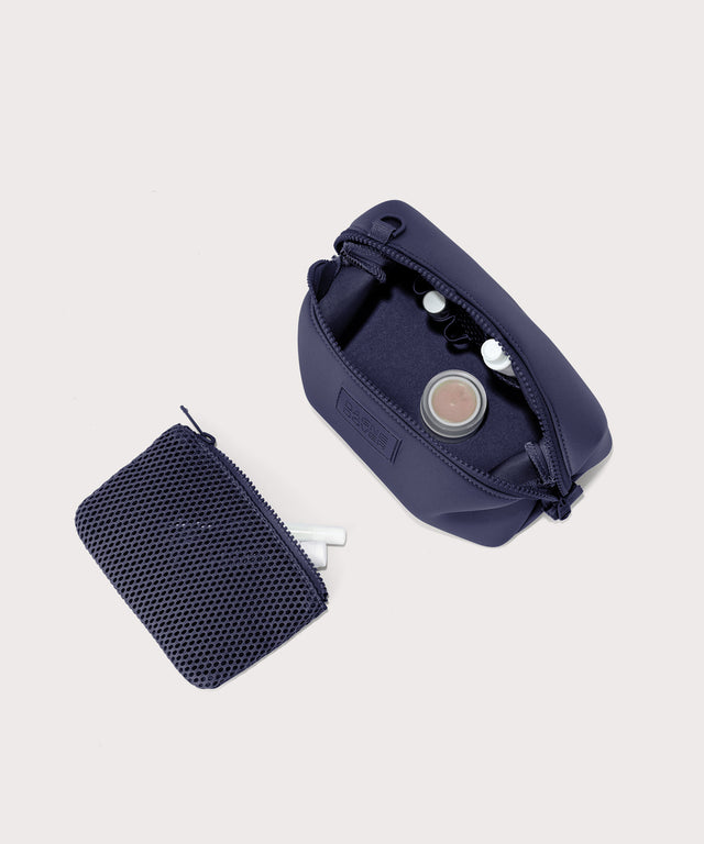 Dagne Dover Small Hunter Toiletry Bag in dark blue unzipped and seen from above with the removable air mesh pouch alongside it.