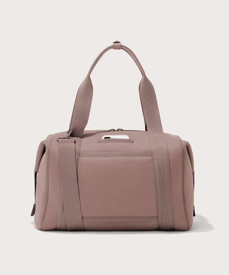 Large Landon Carryall in pink, displaying an exterior phone pocket
