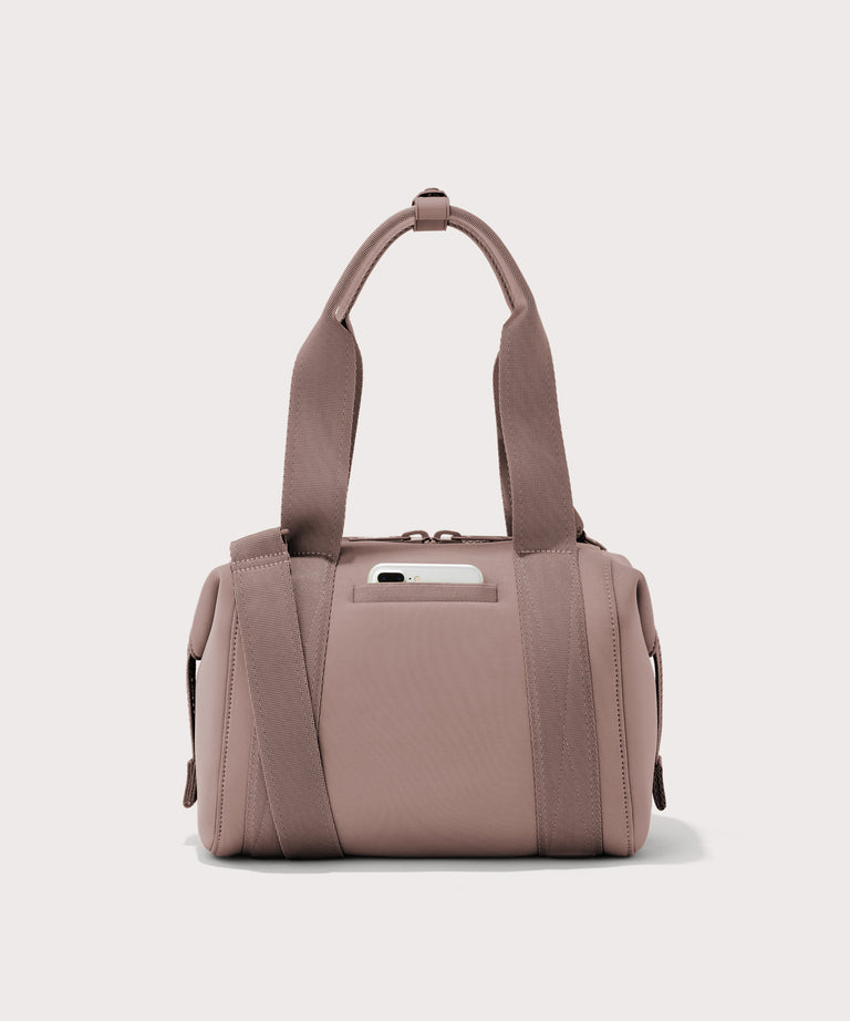small Landon Carryall in pink, displaying an exterior phone pocket
