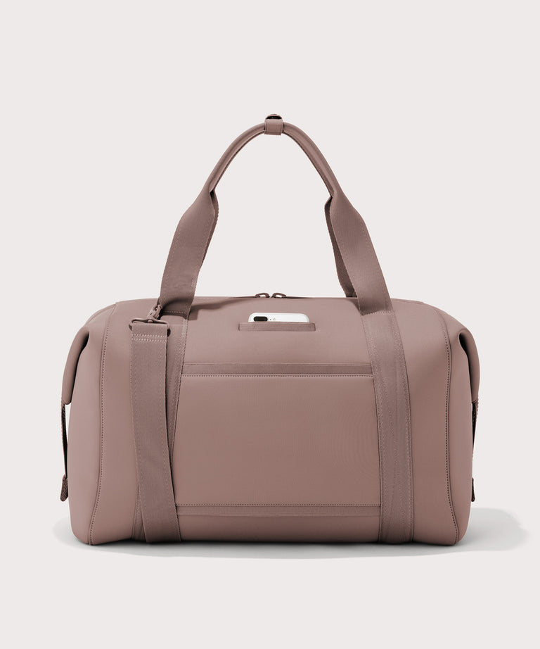 Extra large Landon Carryall in pink, displaying an exterior phone pocket
