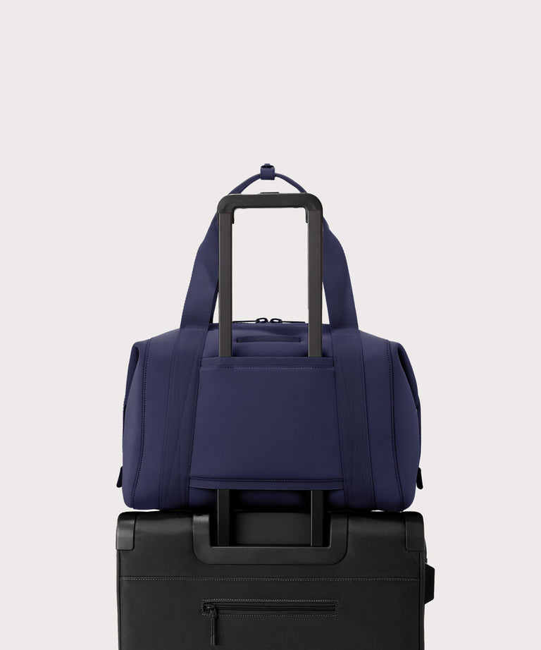 Large Landon Carryall in navy blue displaying luggage sleeve
