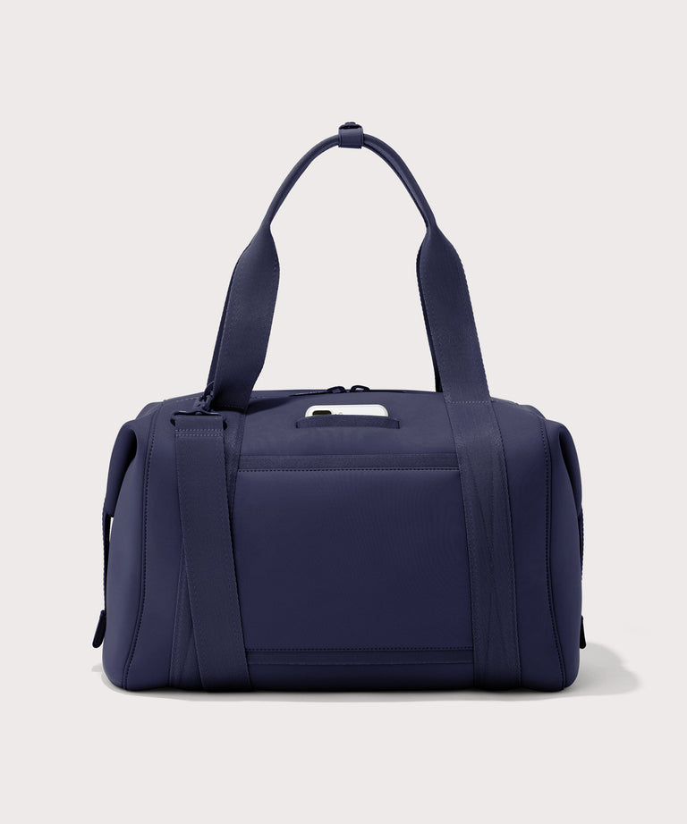 Large Landon Carryall in navy blue, displaying an exterior phone pocket
