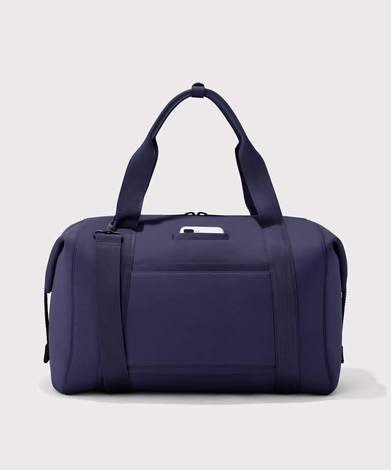 Extra large Landon Carryall in dark blue, displaying an exterior phone pocket
