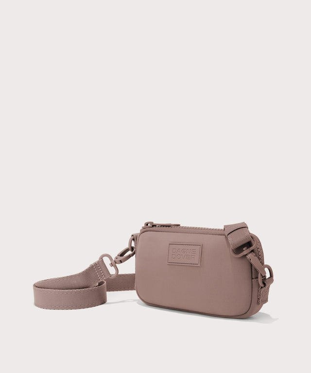 Dagne Dover Mara Phone Sling in pink seen from an angle, showing the adjustable shoulder strap drop.
