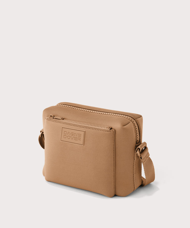 Dagne Dover Micah crossbody in brown camel seen from an angle.
