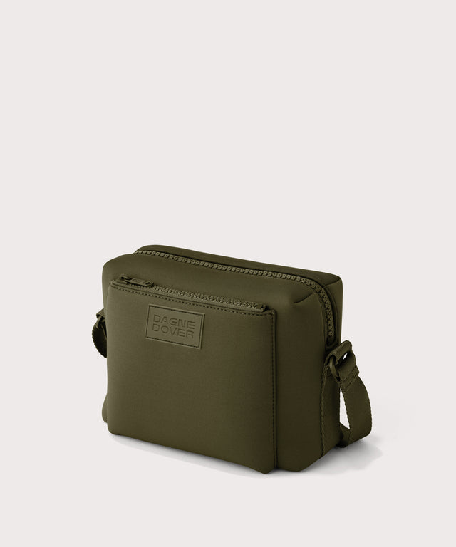 Dagne Dover Micah crossbody in dark green seen from an angle.
