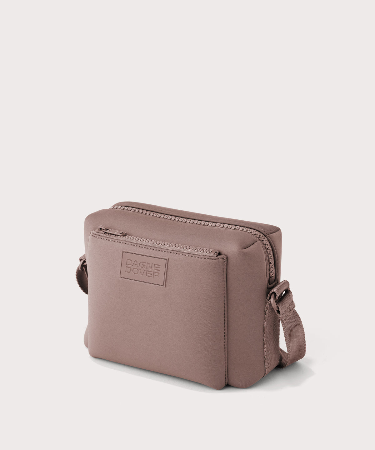 Dagne Dover Micah crossbody in pink seen from an angle.
