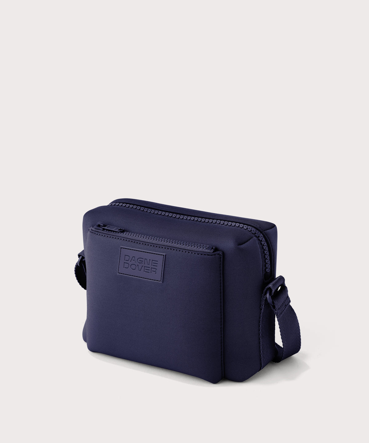 Dagne Dover Micah crossbody in dark blue seen from an angle.

