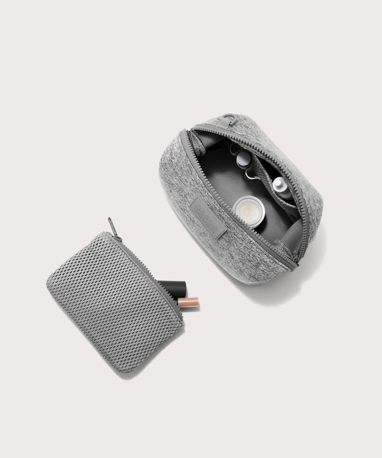 Dagne Dover Small Hunter Toiletry Bag in grey unzipped and seen from above with the removable air mesh pouch alongside it.