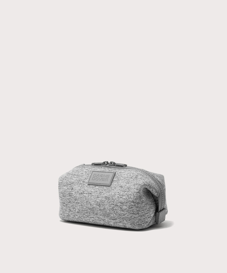 Dagne Dover Small Hunter Toiletry Bag in grey seen from an angle.
