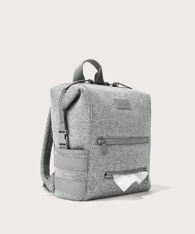 Dagne Dover Medium Indi Diaper Backpack in grey showing the zipper opening for easy access wipes.

