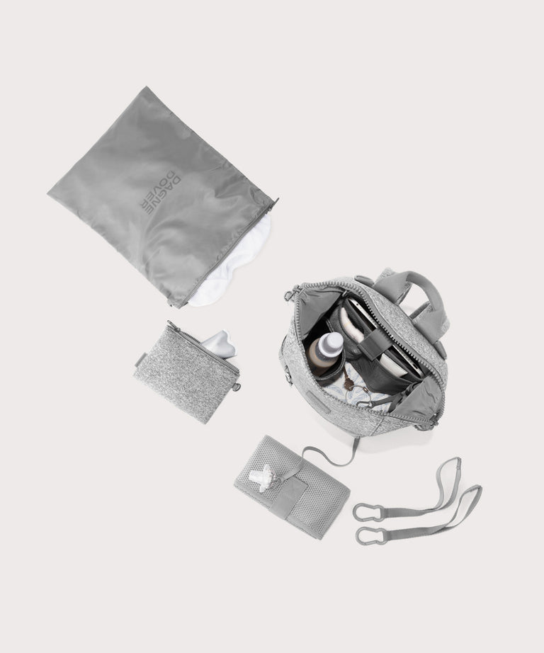 Dagne Dover small Indi Diaper Backpack in grey showing it's water resistant bag, interior pockets, and changing mat.