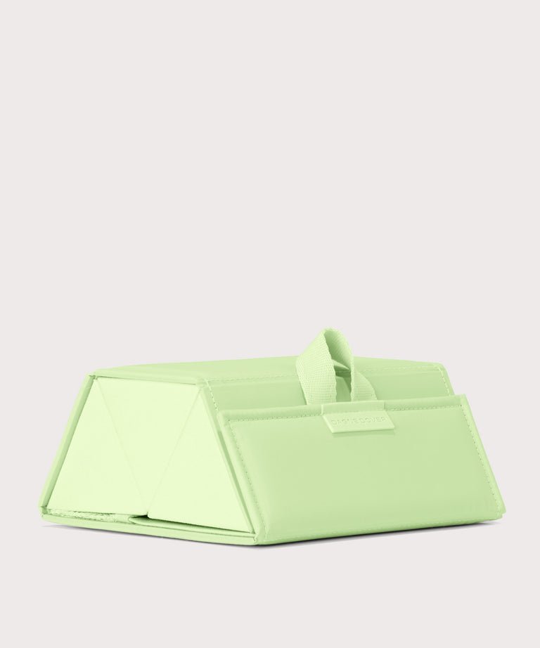 Dagne Dover Remi foldable glasses holder in matcha green seen from an angle.

