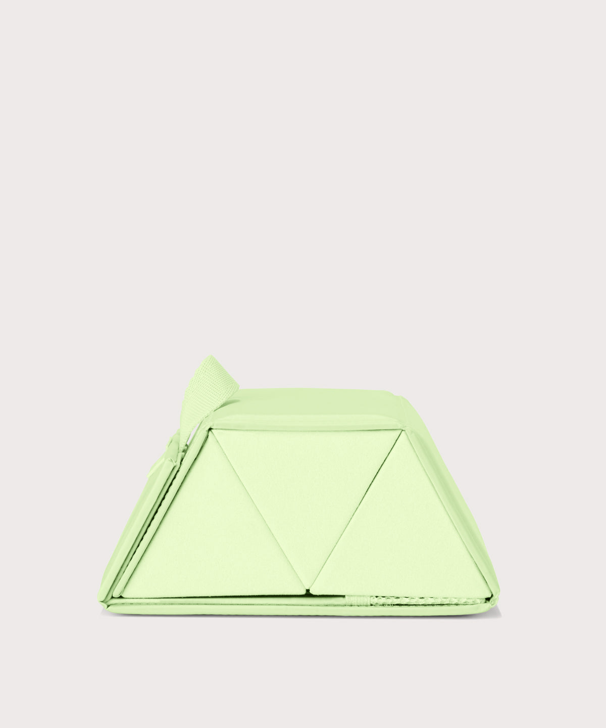 Dagne Dover Remi foldable glasses holder in matcha green seen from the side.
