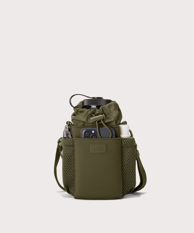 Dagne Dover Sloan Water Bottle Sling in dark green containing a water bottle and accessories.
