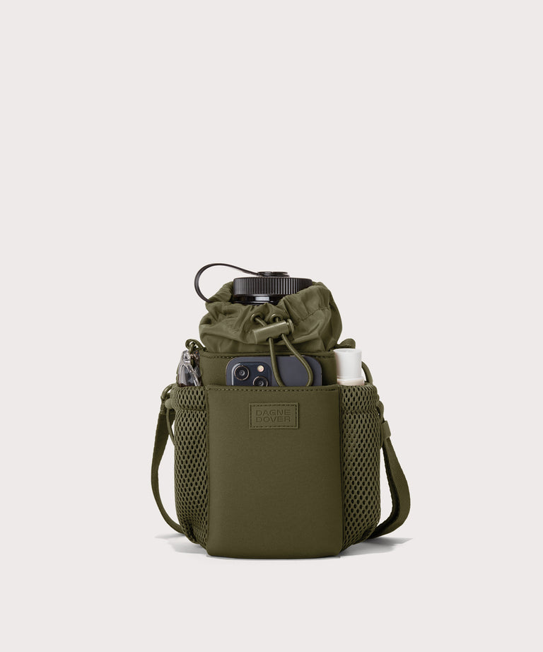 Dagne Dover Sloan Water Bottle Sling in dark green containing a water bottle and accessories.
