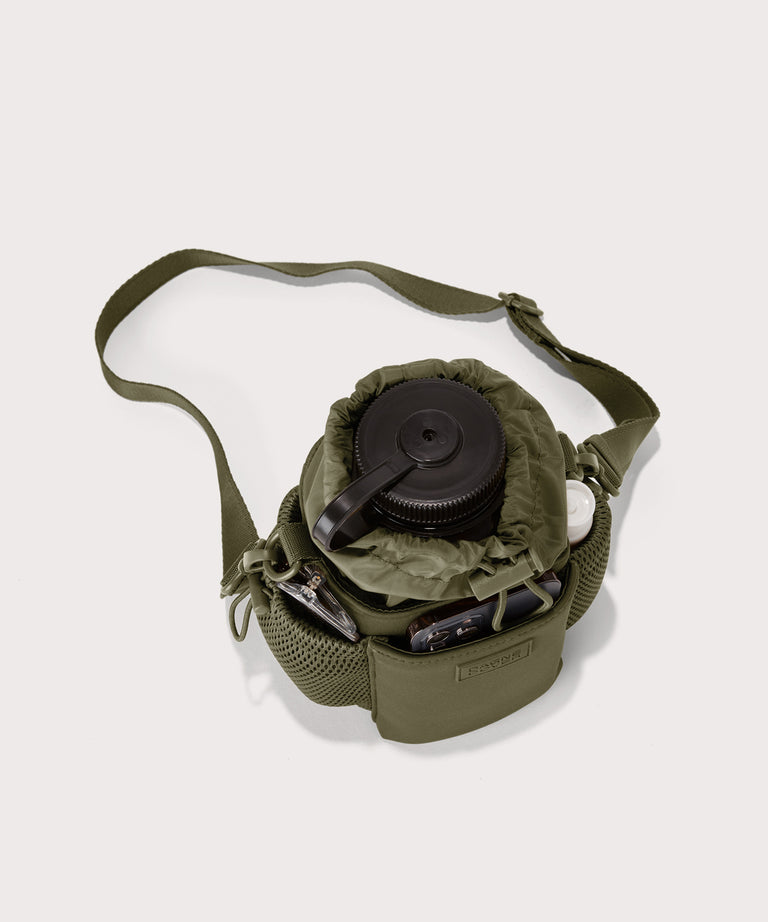 Dagne Dover Sloan Water Bottle Sling in dark green seen from above containing a water bottle and accessories 