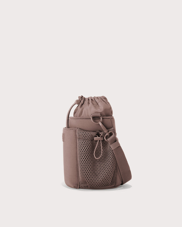 Dagne Dover Sloan Water Bottle Sling in pink seen from an angle.
