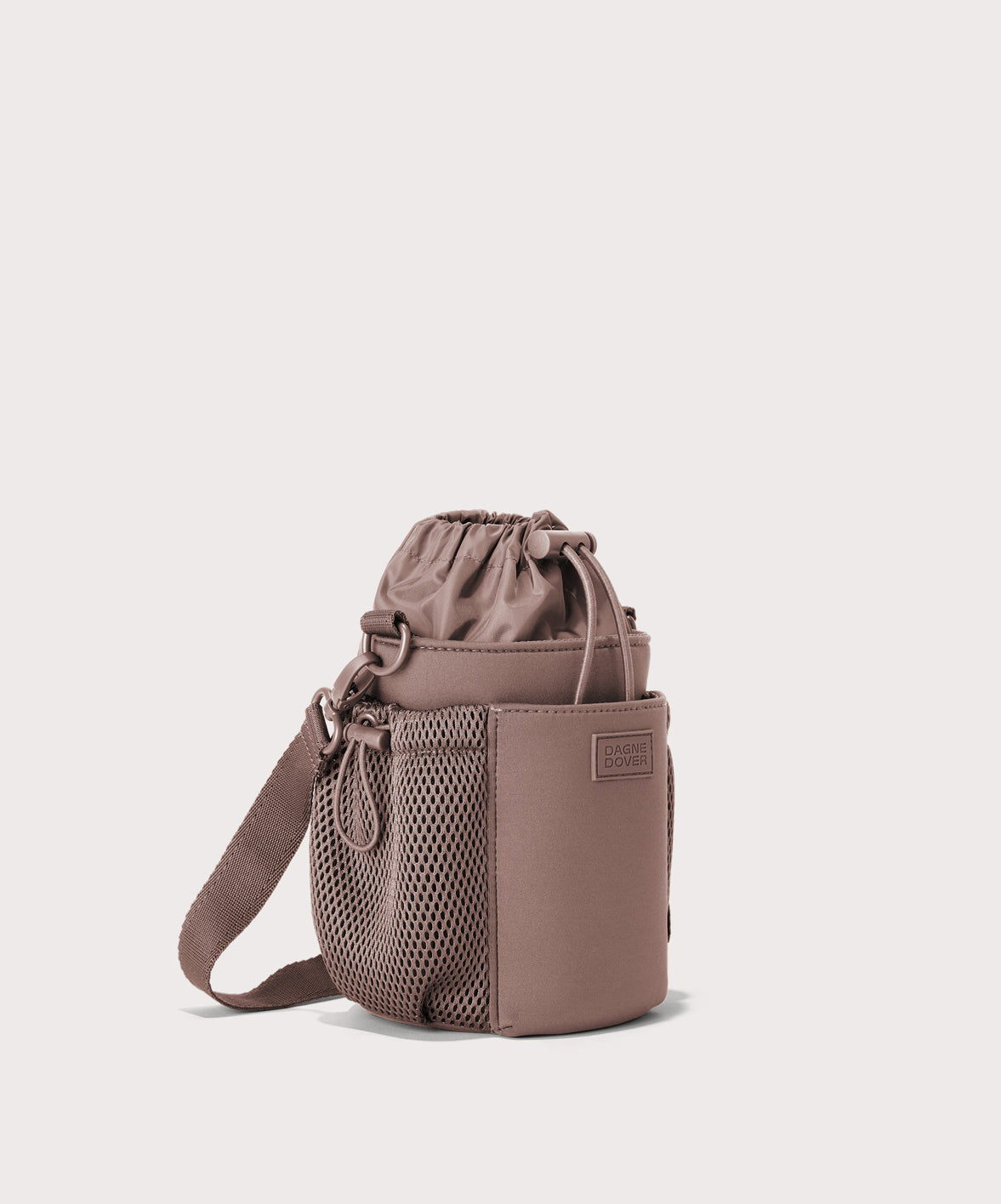 Dagne Dover Sloan Water Bottle Sling in pink seen from an angle.
