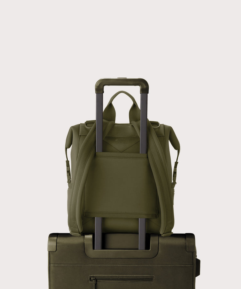 Dagne Dover medium Indi Diaper Backpack in dark moss showing the neoprene luggage sleeve.
