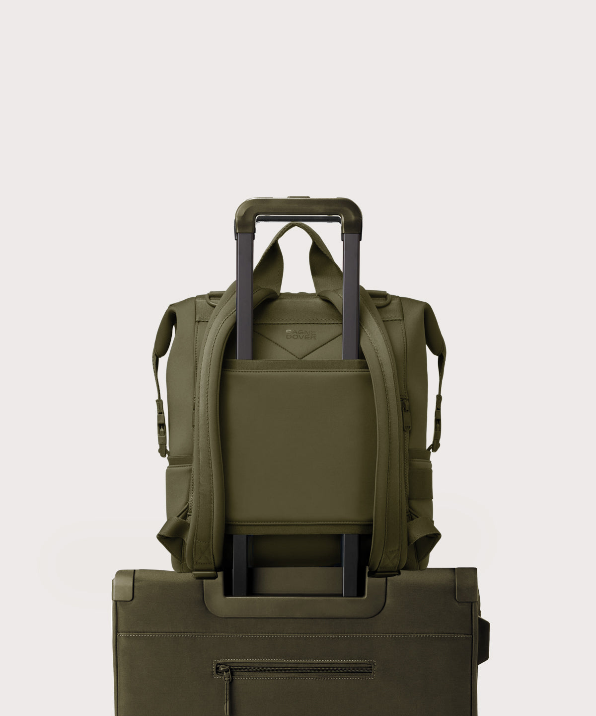 Dagne Dover Large Indi Diaper Backpack in dark moss showing the neoprene luggage sleeve.
