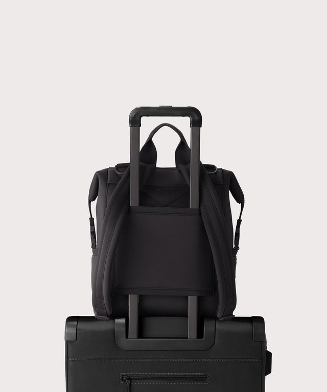 Dagne Dover medium Indi Diaper Backpack in black showing the neoprene luggage sleeve.
