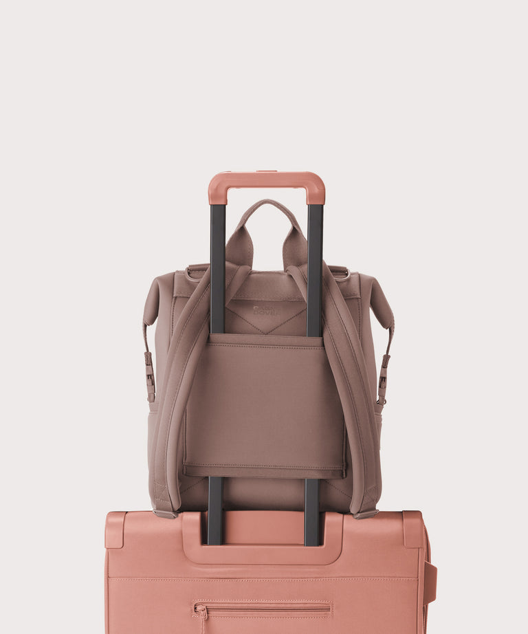 Dagne Dover medium Indi Diaper Backpack in pink showing the neoprene luggage sleeve.

