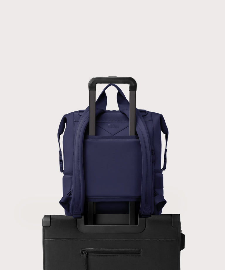 Dagne Dover Large Indi Diaper Backpack in dark blue showing the neoprene luggage sleeve.
