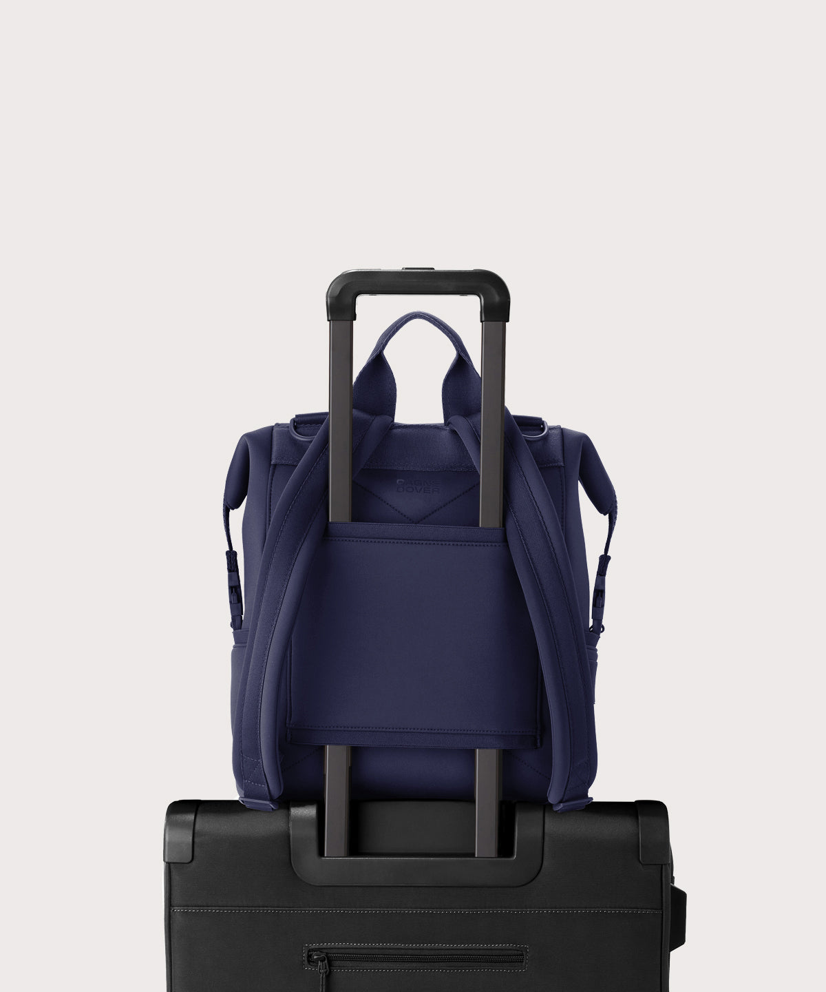 Dagne Dover medium Indi Diaper Backpack in dark blue showing the neoprene luggage sleeve.
