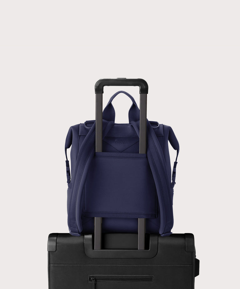 Dagne Dover medium Indi Diaper Backpack in dark blue showing the neoprene luggage sleeve.

