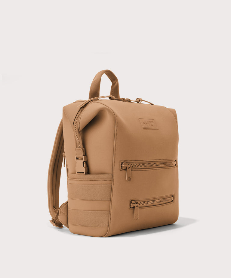 Dagne Dover Medium Indi Diaper Backpack in camel brown seen from an angle.
