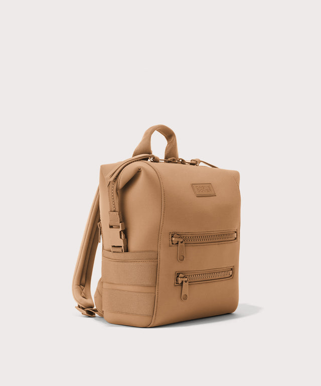 Dagne Dover small Indi Diaper Backpack in camel brown seen from an angle.
