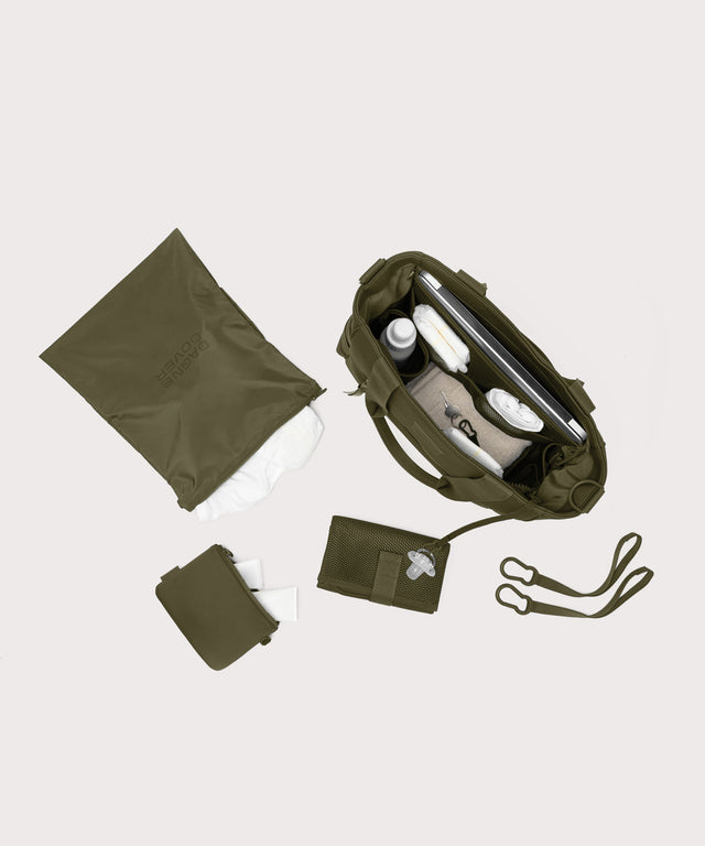 Dagne Dover large Wade Diaper Tote in dark green seen from above, alongside the changing mat, neoprene pouch, and water resistant zipper bag.