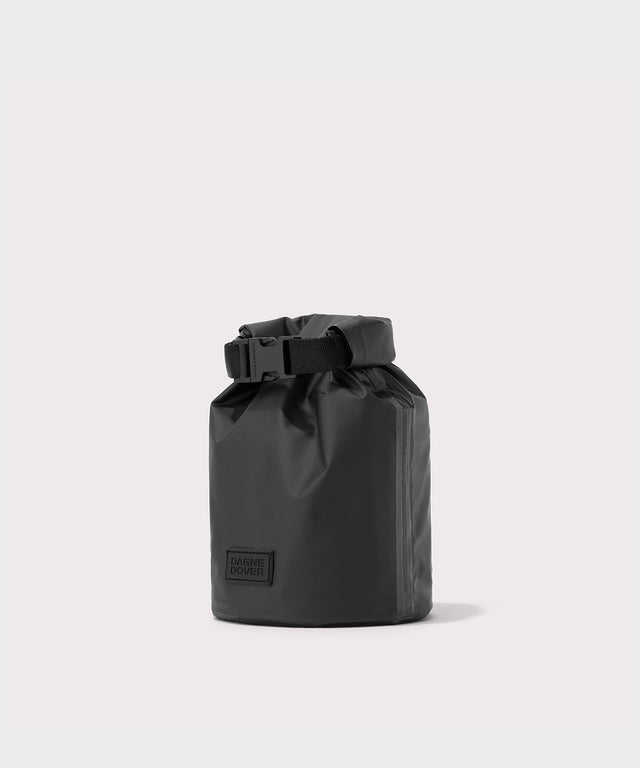 Dagne Dover Rae Roll-Top Dry Bag in black seen from an angle.
