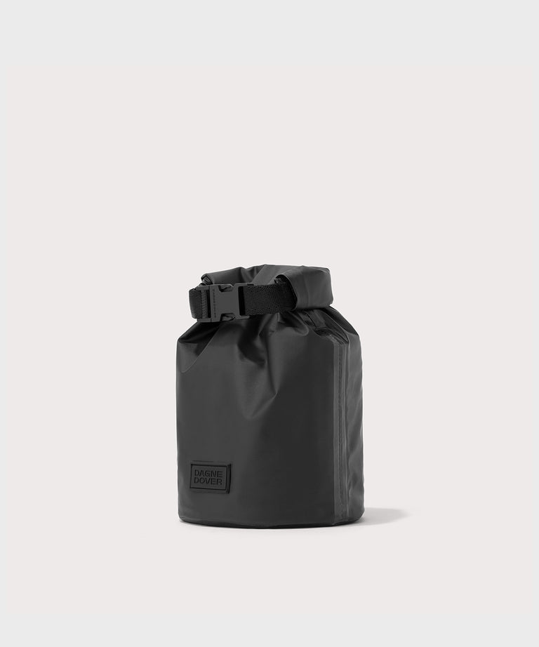 Dagne Dover Rae Roll-Top Dry Bag in black seen from an angle.
